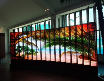 LED screen displaying tropical beach scene.