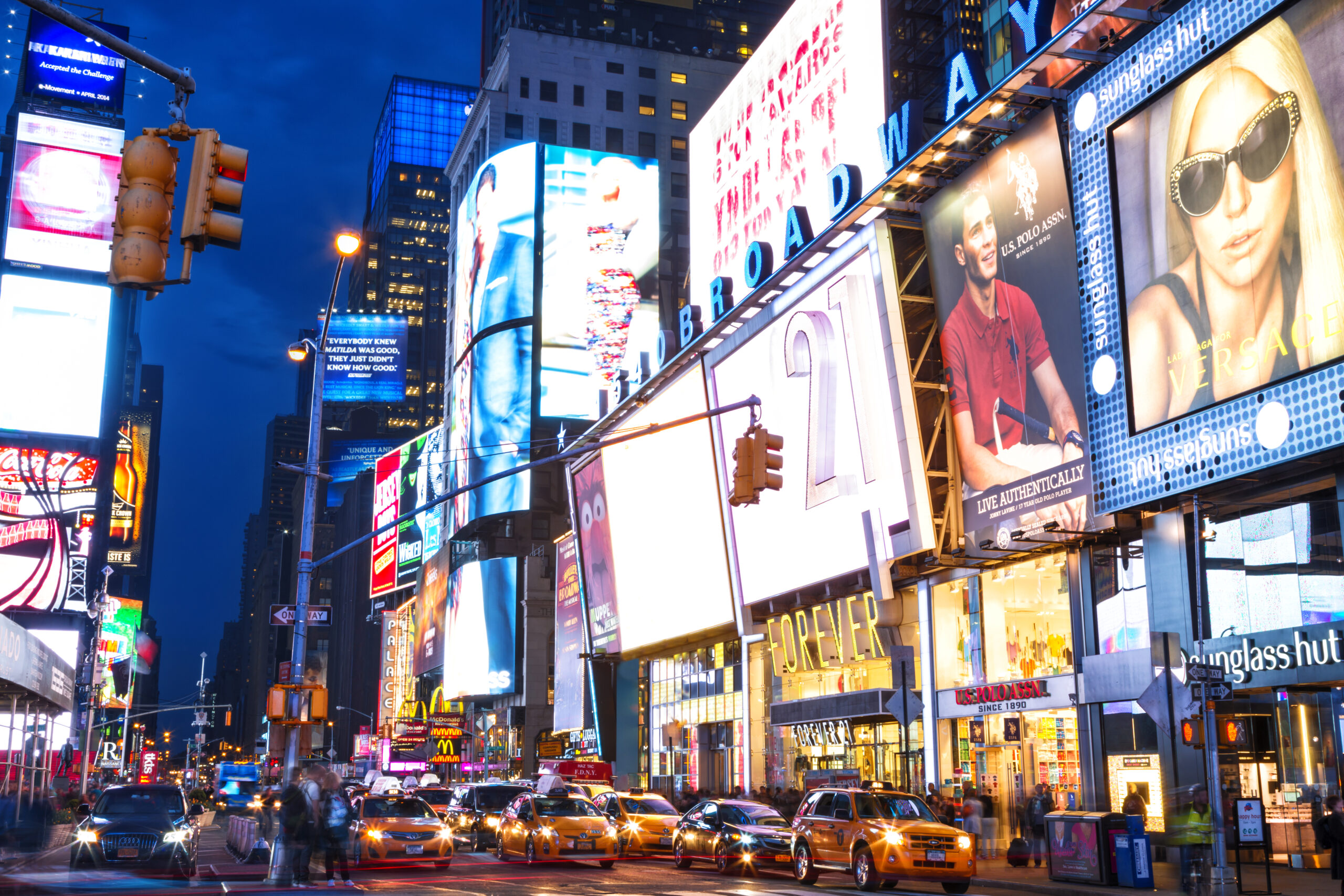 Neon lights illuminating Times Square taxis