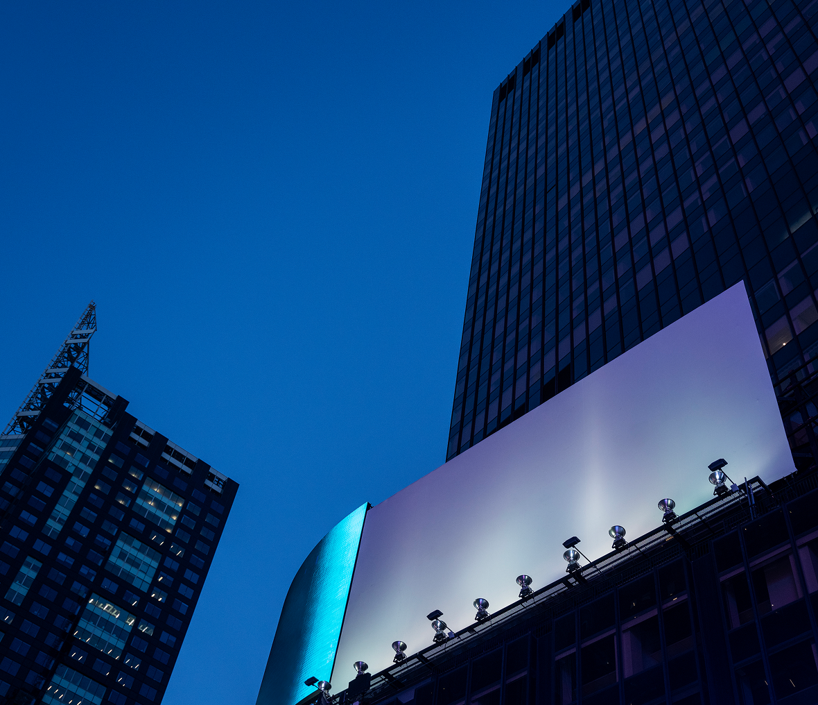 Urban skyline with illuminated billboard